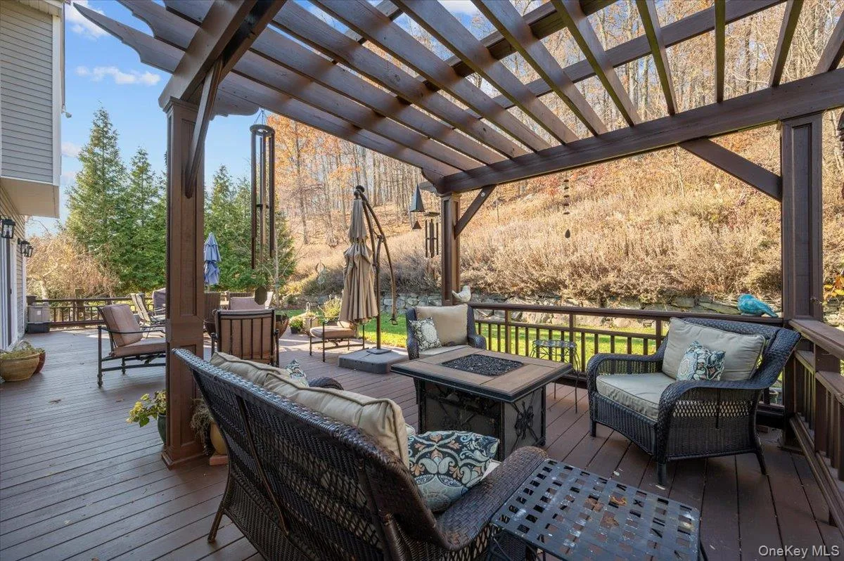 Deck featuring an outdoor living space with a fire pit Deck featuring an outdoor living space with a fire pit