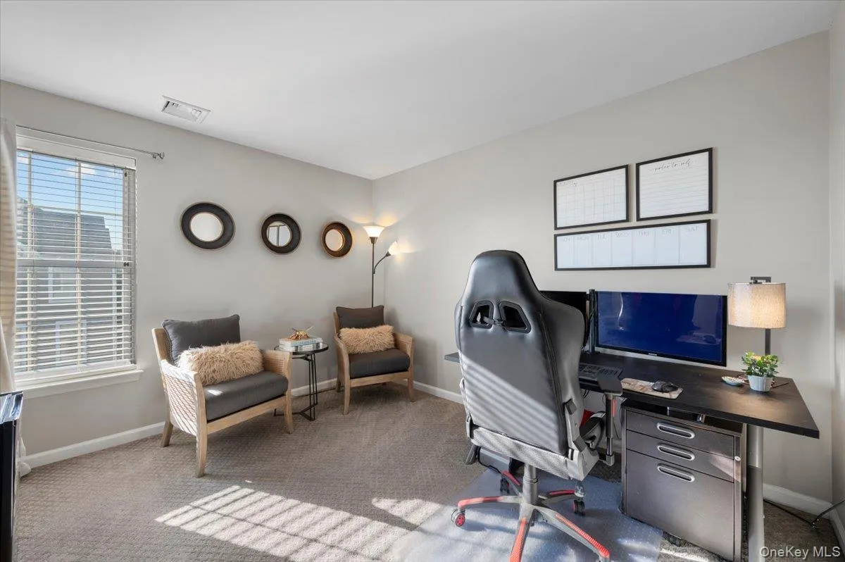 Carpeted office space with baseboards Carpeted office space with baseboards