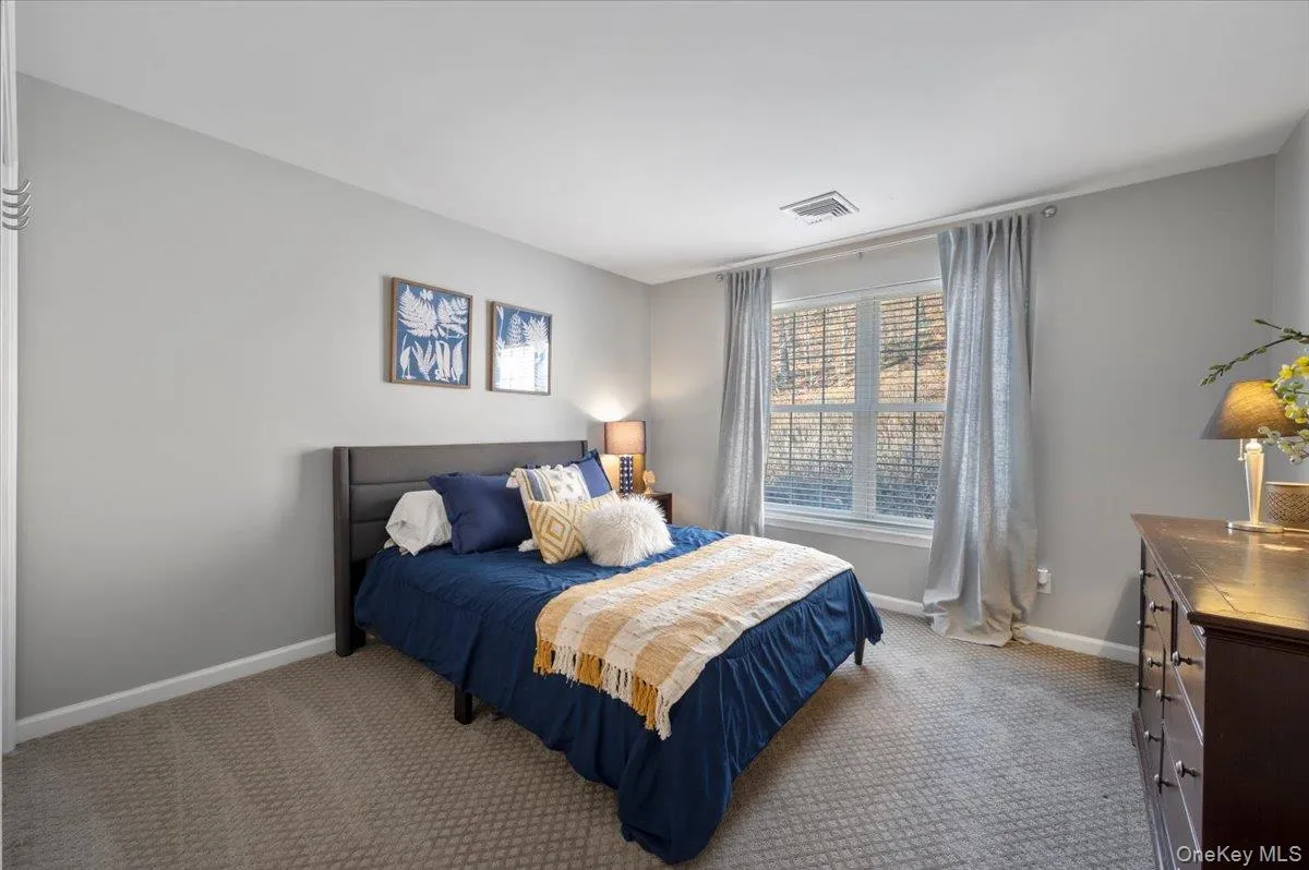 Carpeted bedroom featuring baseboards Carpeted bedroom featuring baseboards