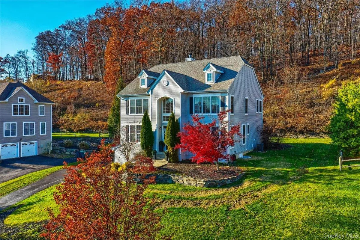 View of front of house with a chimney, a front yard, driveway, a garage, and roof with shingles View of front of house with a chimney, a front yard, driveway, a garage, and roof with shingles