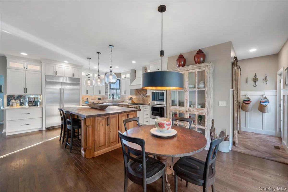 Dining space featuring dark wood-style flooring and recessed lighting Dining space featuring dark wood-style flooring and recessed lighting