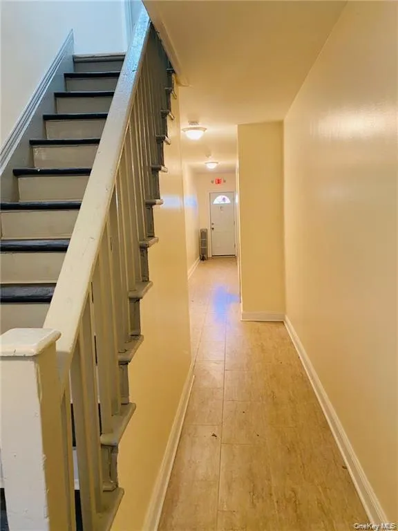Hall with stairway and light wood-style flooring Hall with stairway and light wood-style flooring