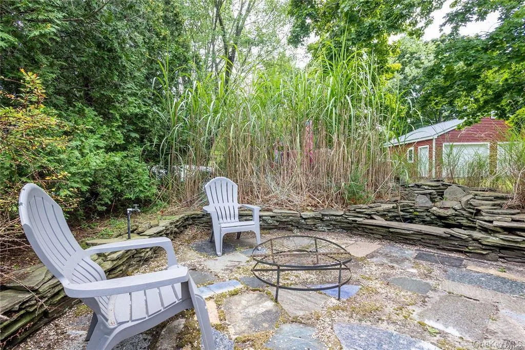 View of patio / terrace with an outdoor fire pit View of patio / terrace with an outdoor fire pit