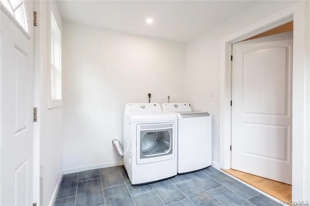 Laundry room featuring healthy amount of natural light, washing machine and clothes dryer, and recessed lighting Laundry room featuring healthy amount of natural light, washing machine and clothes dryer, and recessed lighting
