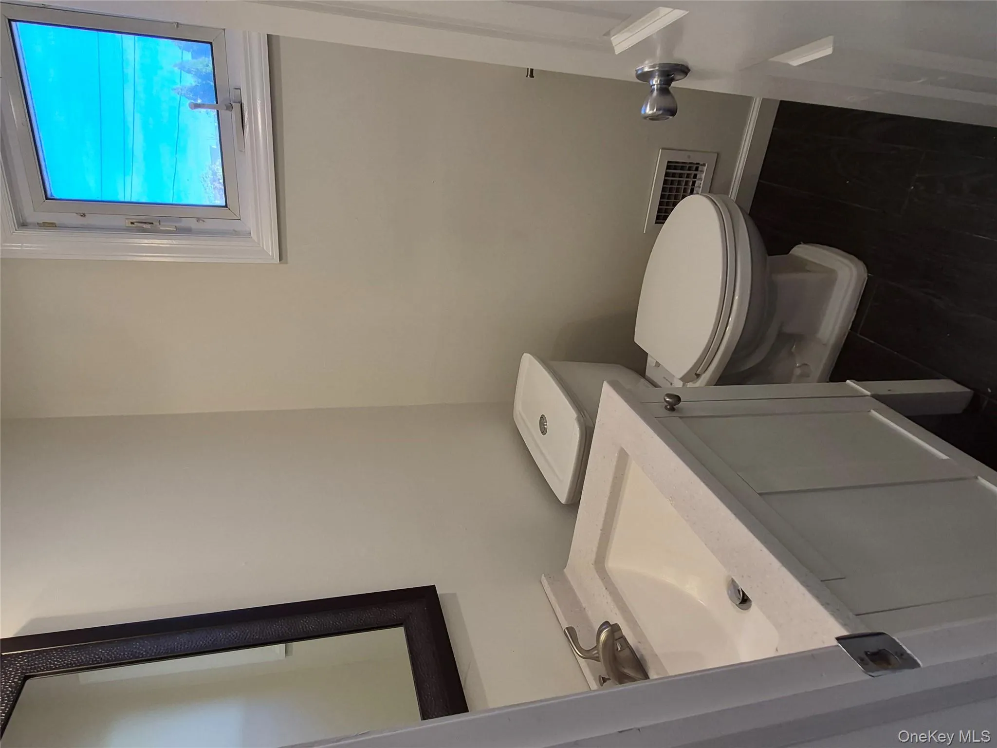 Half bathroom with vanity and dark wood-style flooring Half bathroom with vanity and dark wood-style flooring