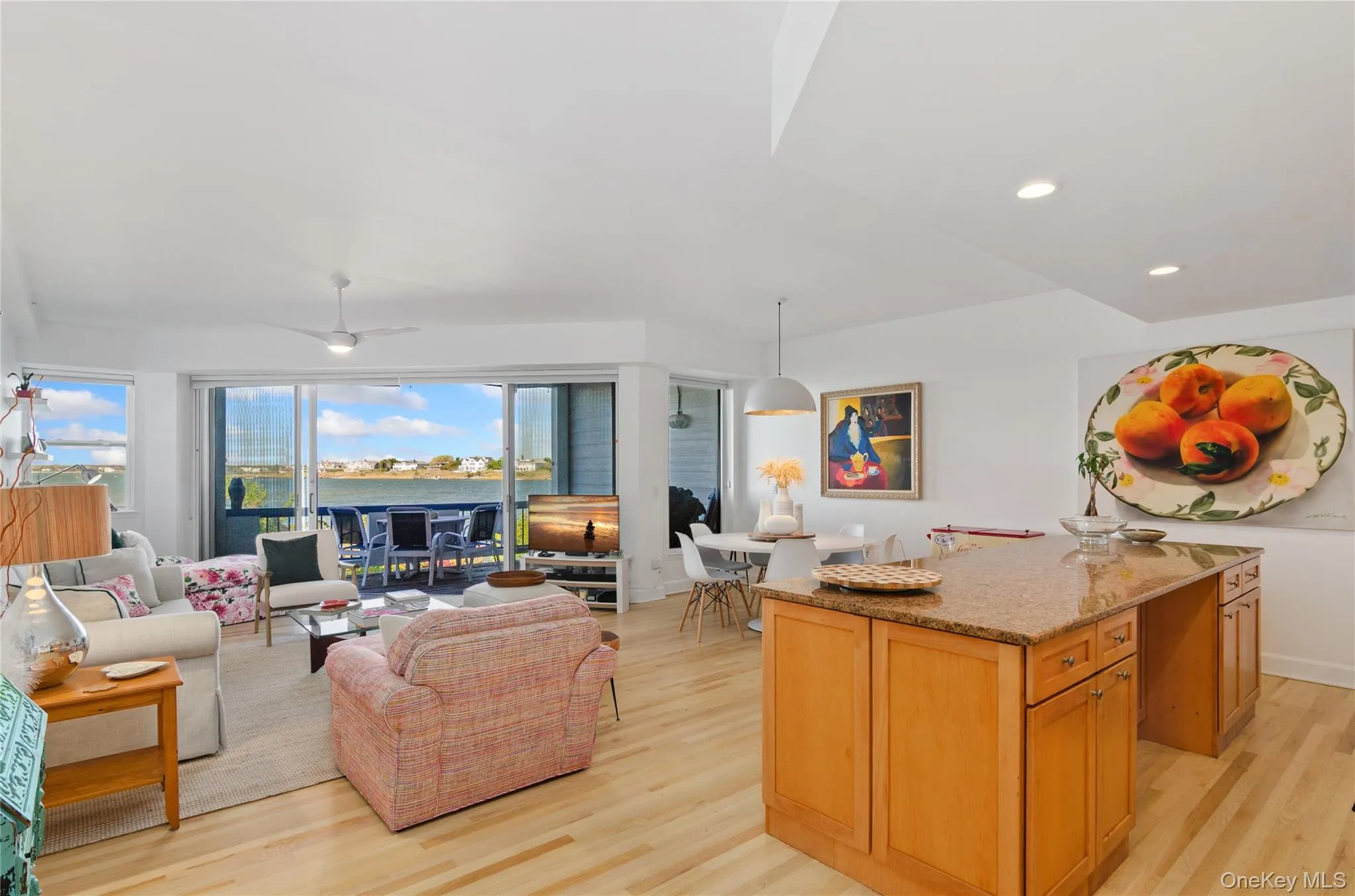 Living area with light wood-style flooring and recessed lighting Living area with light wood-style flooring and recessed lighting
