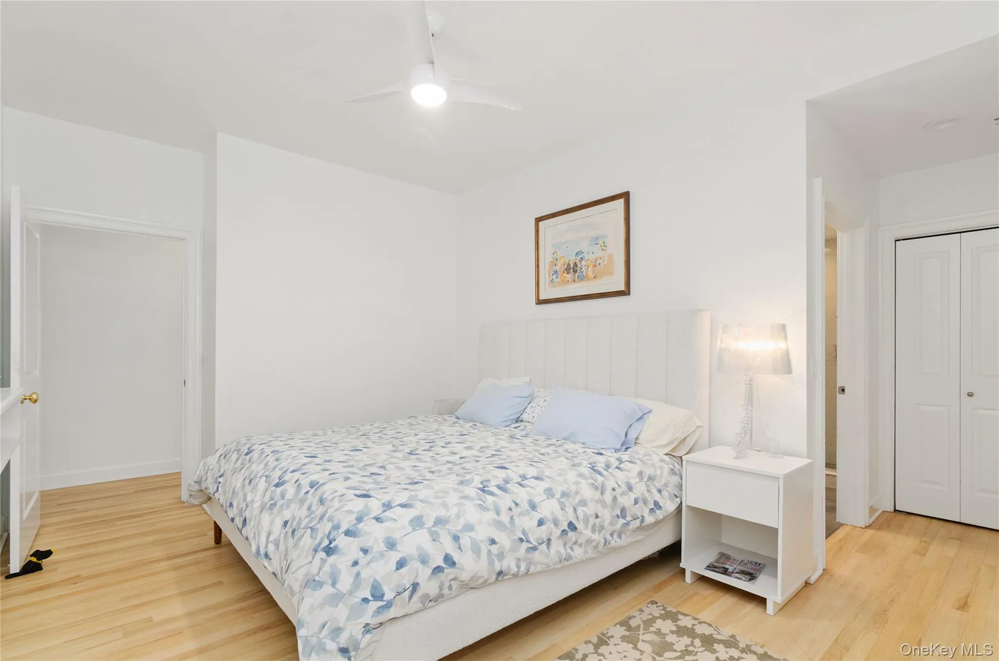 Bedroom featuring light wood-type flooring, a ceiling fan, and a closet Bedroom featuring light wood-type flooring, a ceiling fan, and a closet
