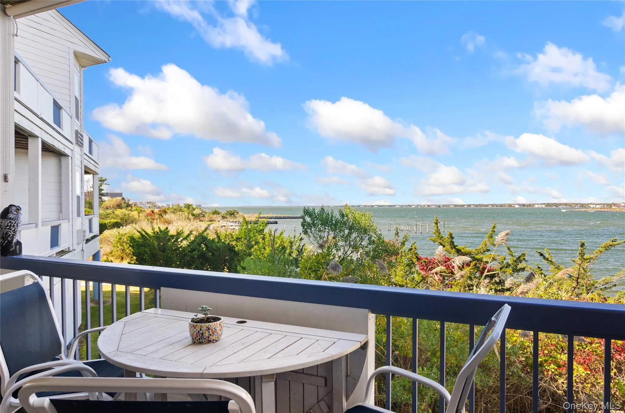 Balcony featuring a water view and outdoor dining area Balcony featuring a water view and outdoor dining area