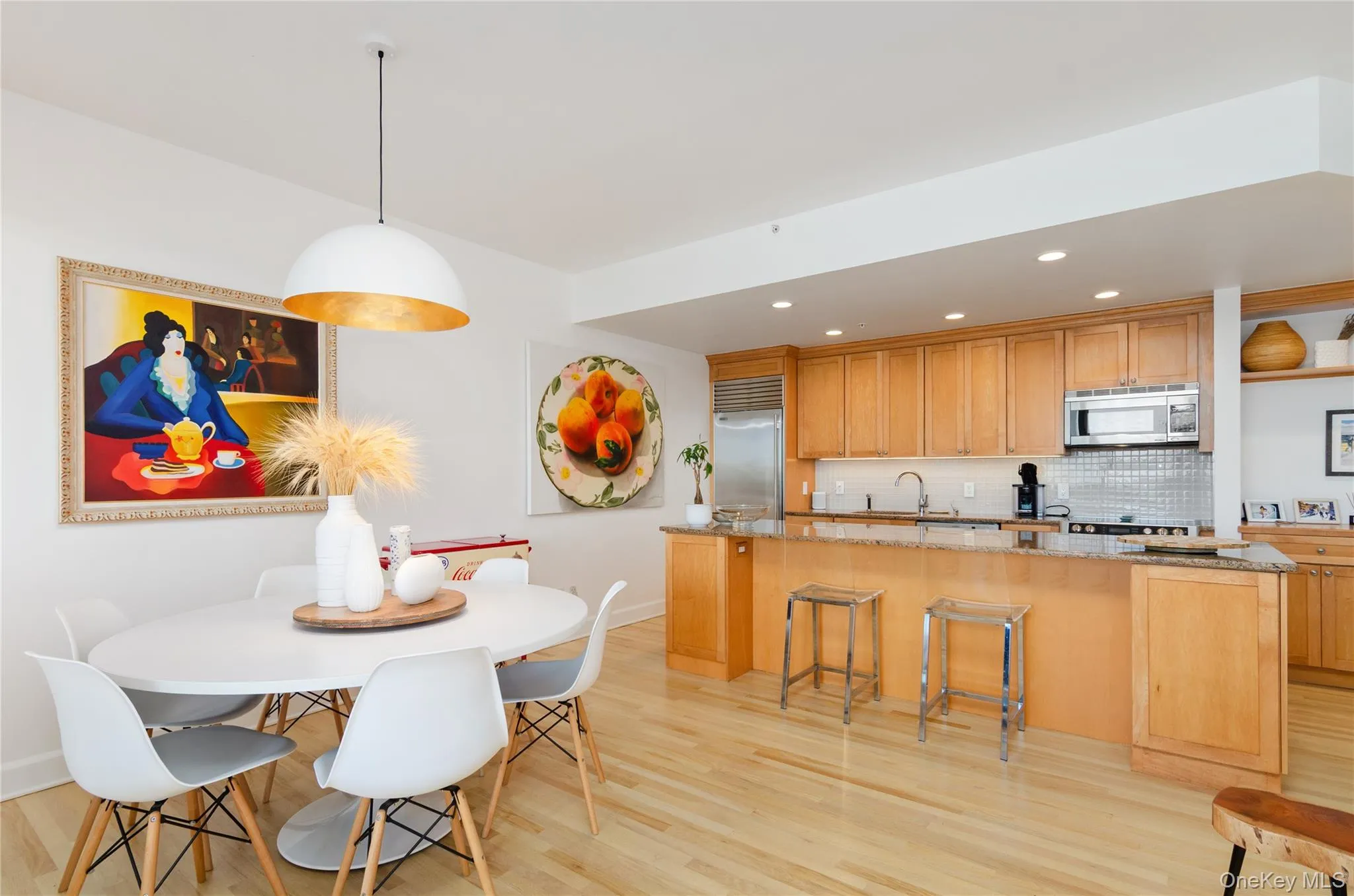 Dining room featuring light wood-type flooring and recessed lighting Dining room featuring light wood-type flooring and recessed lighting