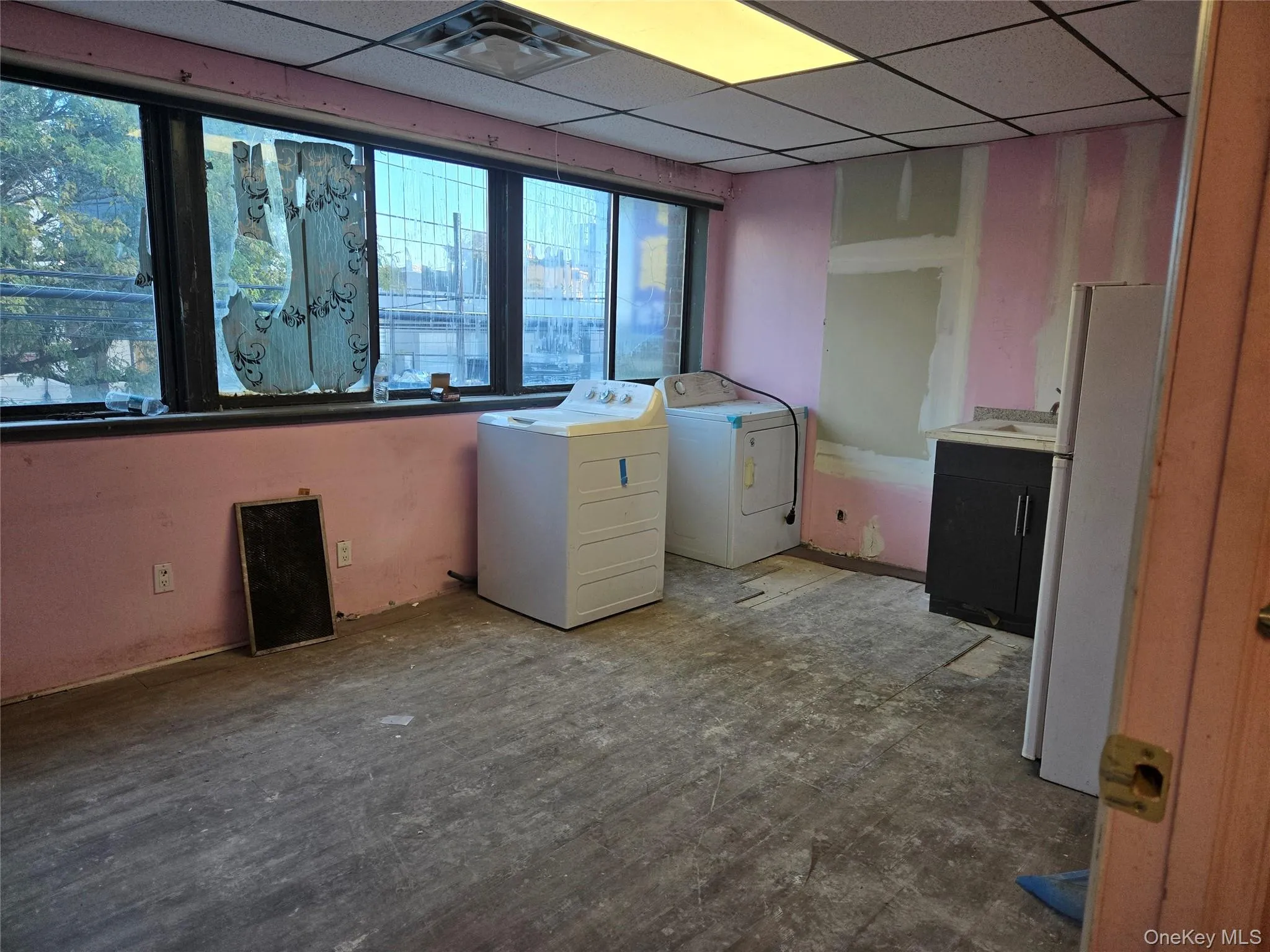 Laundry area with a drop ceiling and washing machine and dryer Laundry area with a drop ceiling and washing machine and dryer