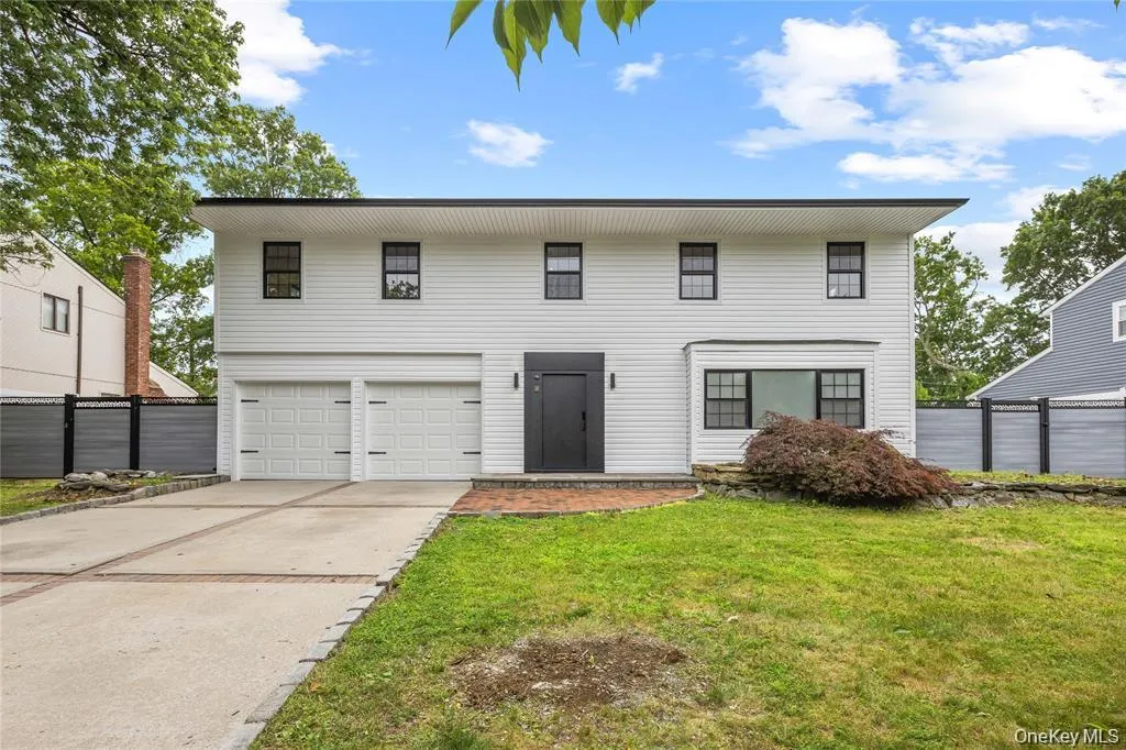 View of front of property with driveway and an attached garage View of front of property with driveway and an attached garage