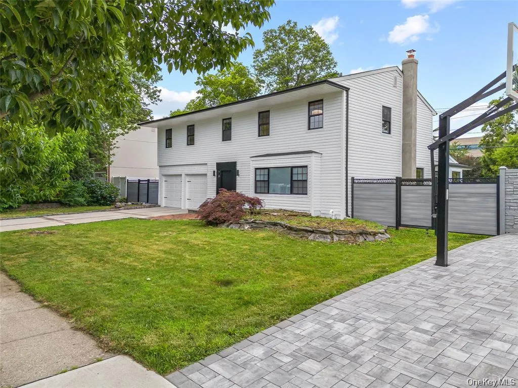 View of front of home with concrete driveway, a chimney, and a garage View of front of home with concrete driveway, a chimney, and a garage