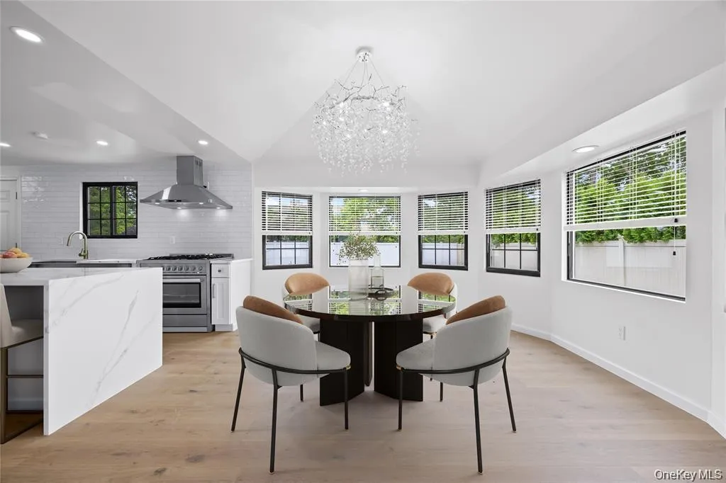 Dining space featuring light wood-style floors, recessed lighting, and a chandelier Dining space featuring light wood-style floors, recessed lighting, and a chandelier