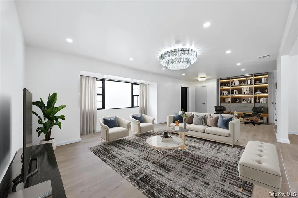 Living area with an office area, recessed lighting, light wood-style floors, and a chandelier Living area with an office area, recessed lighting, light wood-style floors, and a chandelier