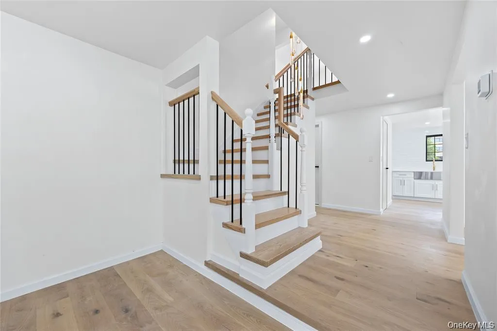 Staircase with wood finished floors and recessed lighting Staircase with wood finished floors and recessed lighting