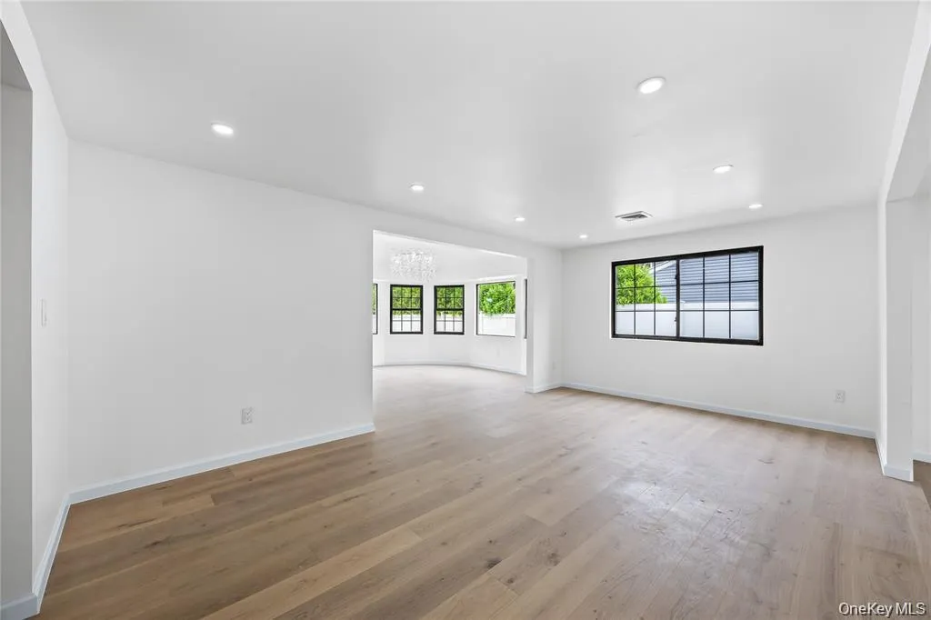 Spare room with light wood-style floors, recessed lighting, and a chandelier Spare room with light wood-style floors, recessed lighting, and a chandelier