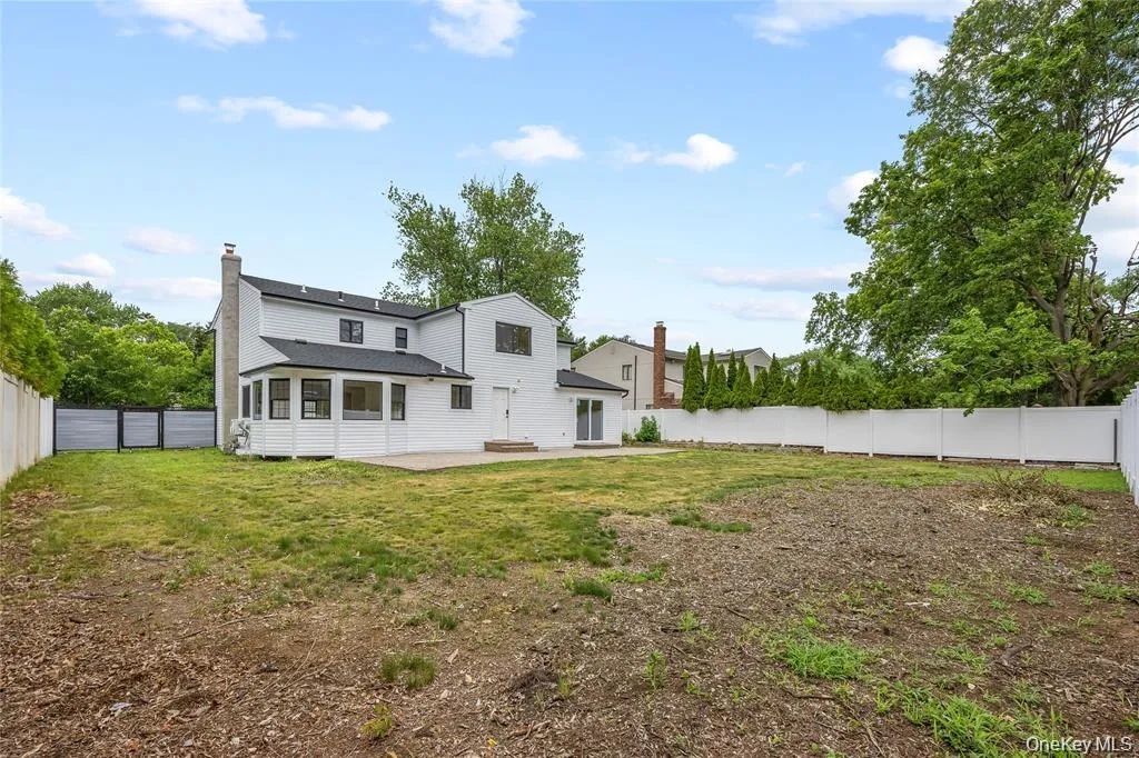 Rear view of property with a patio, a fenced backyard, and a chimney Rear view of property with a patio, a fenced backyard, and a chimney
