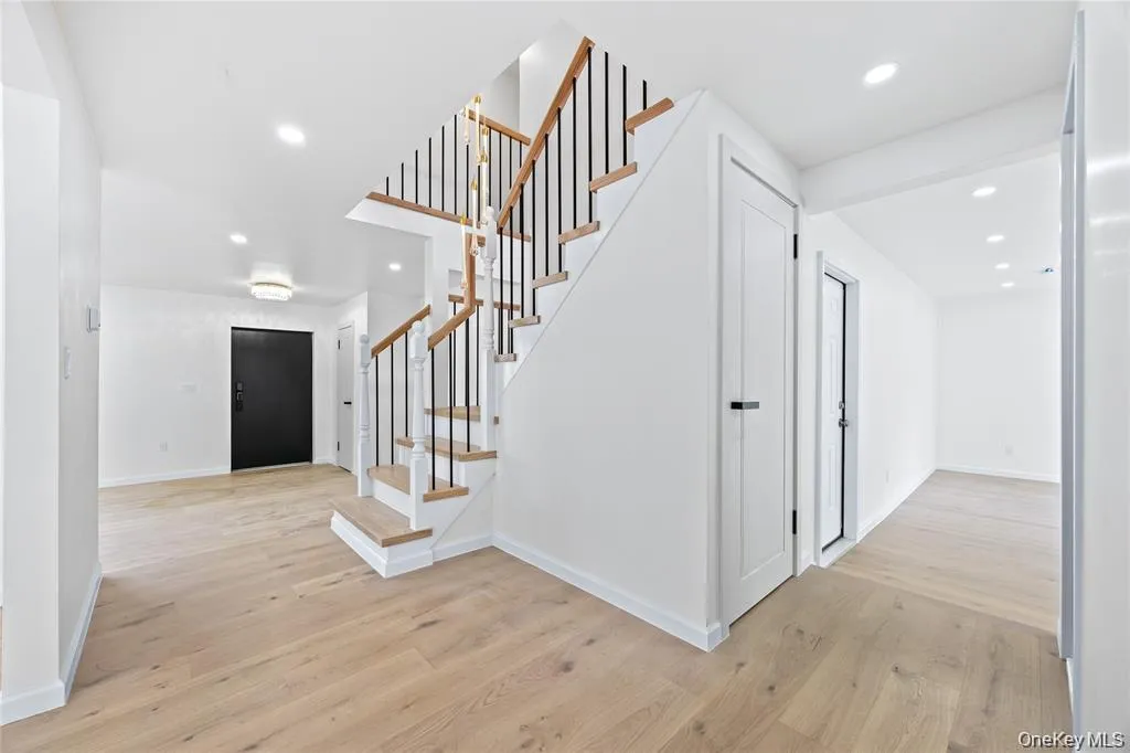 Stairway featuring wood finished floors and recessed lighting Stairway featuring wood finished floors and recessed lighting