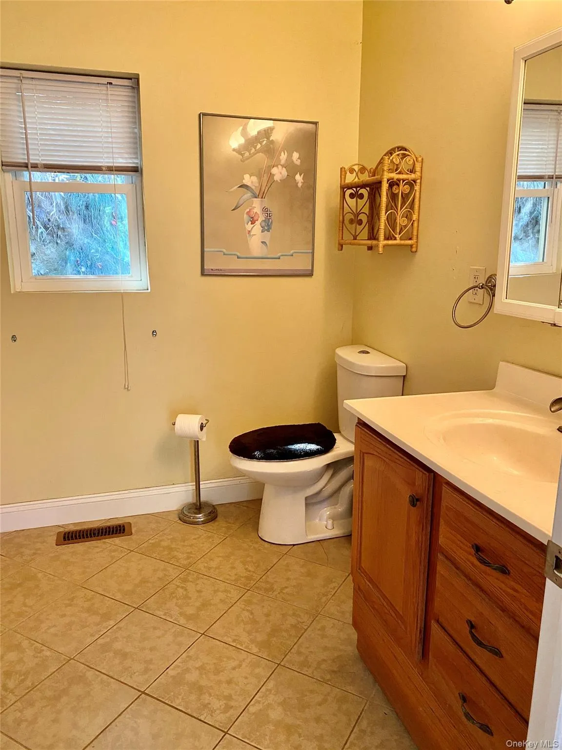 Half bath with vanity and light tile patterned floors Half bath with vanity and light tile patterned floors