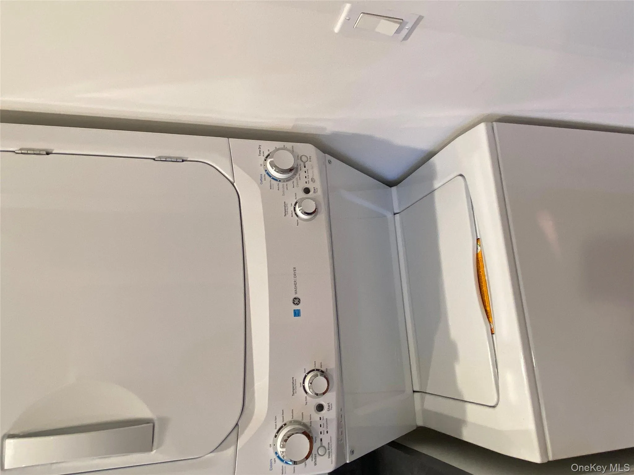 Laundry room with stacked washing machine and dryer Laundry room with stacked washing machine and dryer