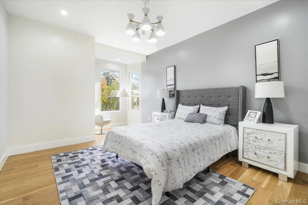 Bedroom with a chandelier, light wood-style floors, and recessed lighting Bedroom with a chandelier, light wood-style floors, and recessed lighting