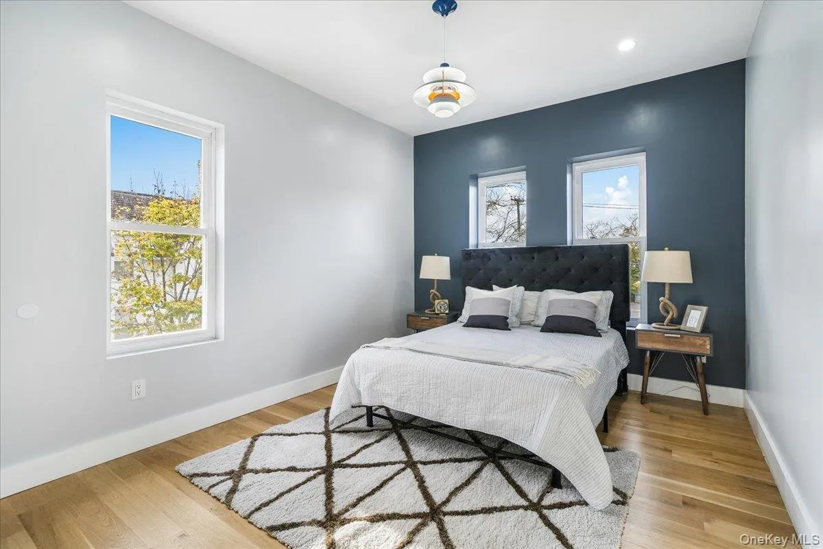 Bedroom featuring light wood-style floors and recessed lighting Bedroom featuring light wood-style floors and recessed lighting