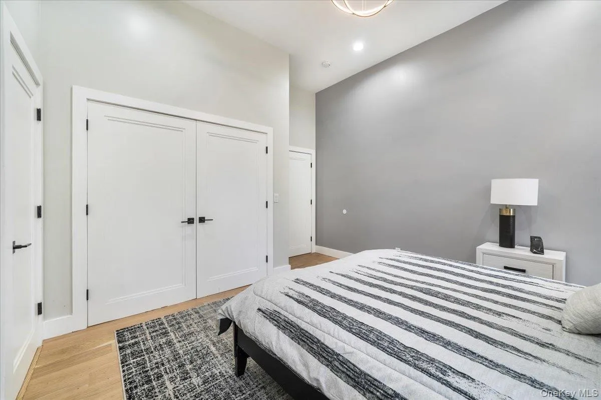 Bedroom featuring light wood-style flooring, a closet, and recessed lighting Bedroom featuring light wood-style flooring, a closet, and recessed lighting