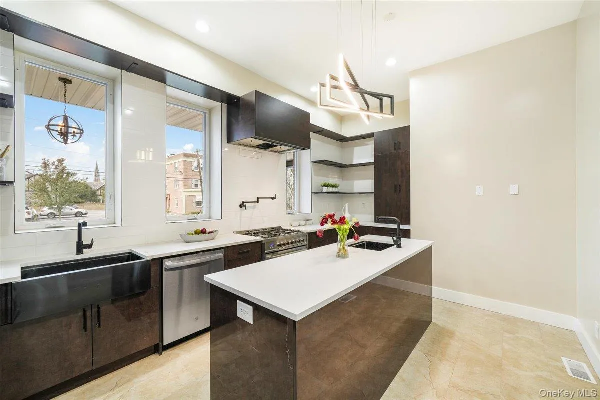 Kitchen featuring open shelves, a center island with sink, modern cabinets, wall chimney exhaust hood, and recessed lighting Kitchen featuring open shelves, a center island with sink, modern cabinets, wall chimney exhaust hood, and recessed lighting