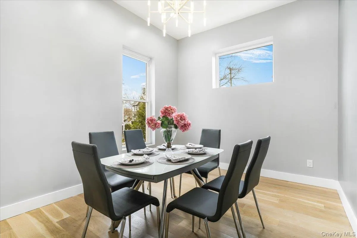Dining area featuring light wood finished floors and a chandelier Dining area featuring light wood finished floors and a chandelier