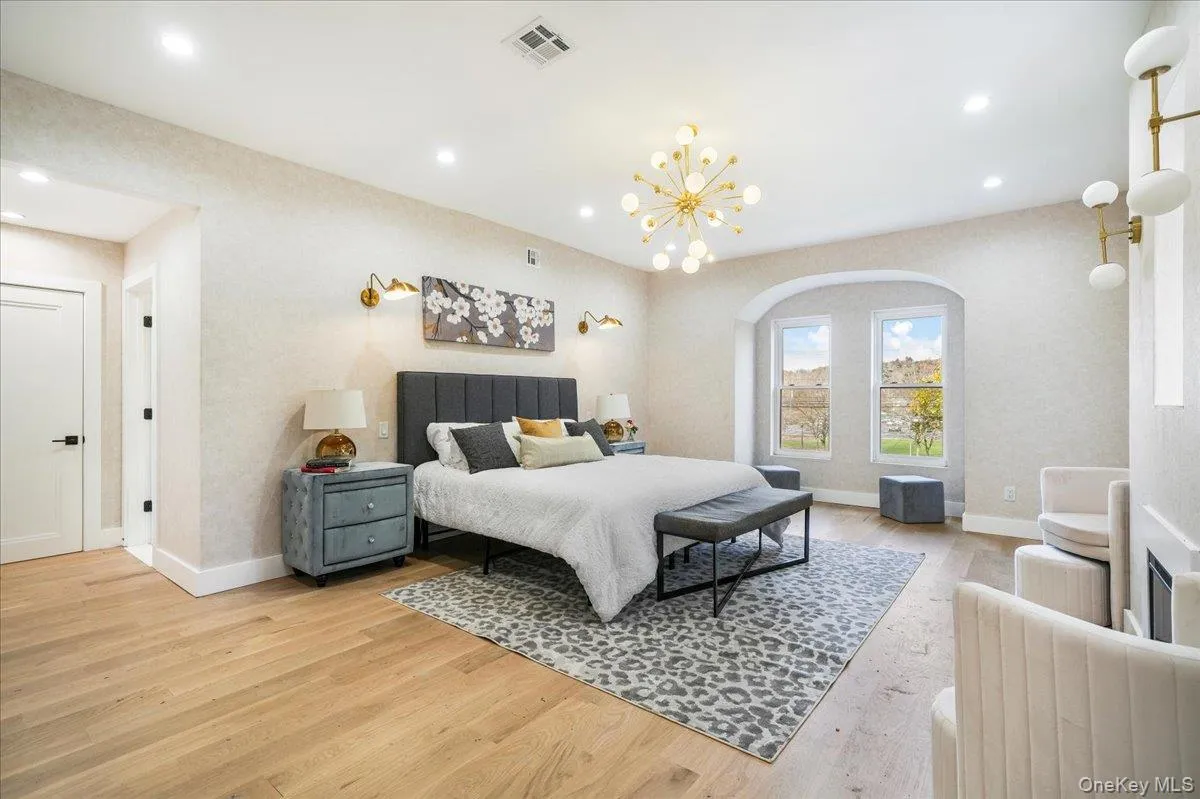 Bedroom with light wood-type flooring, a chandelier, and recessed lighting Bedroom with light wood-type flooring, a chandelier, and recessed lighting