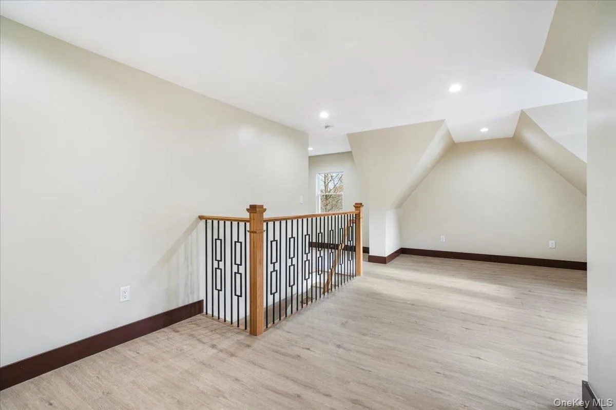 Additional living space with light wood-style floors and recessed lighting Additional living space with light wood-style floors and recessed lighting