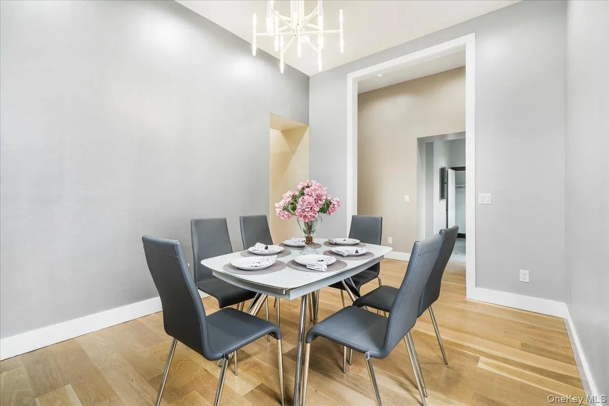 Dining room featuring light wood-style flooring and a chandelier Dining room featuring light wood-style flooring and a chandelier