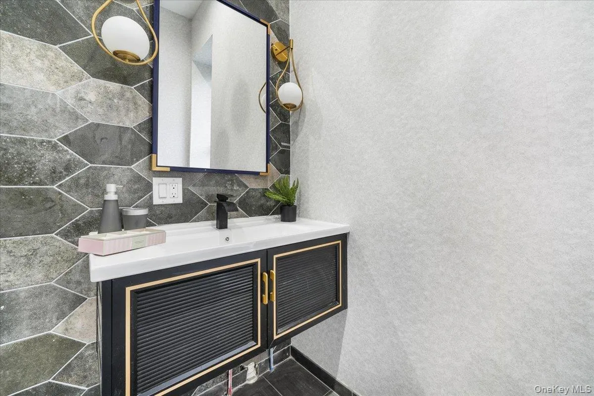 Bathroom featuring vanity and tasteful backsplash Bathroom featuring vanity and tasteful backsplash