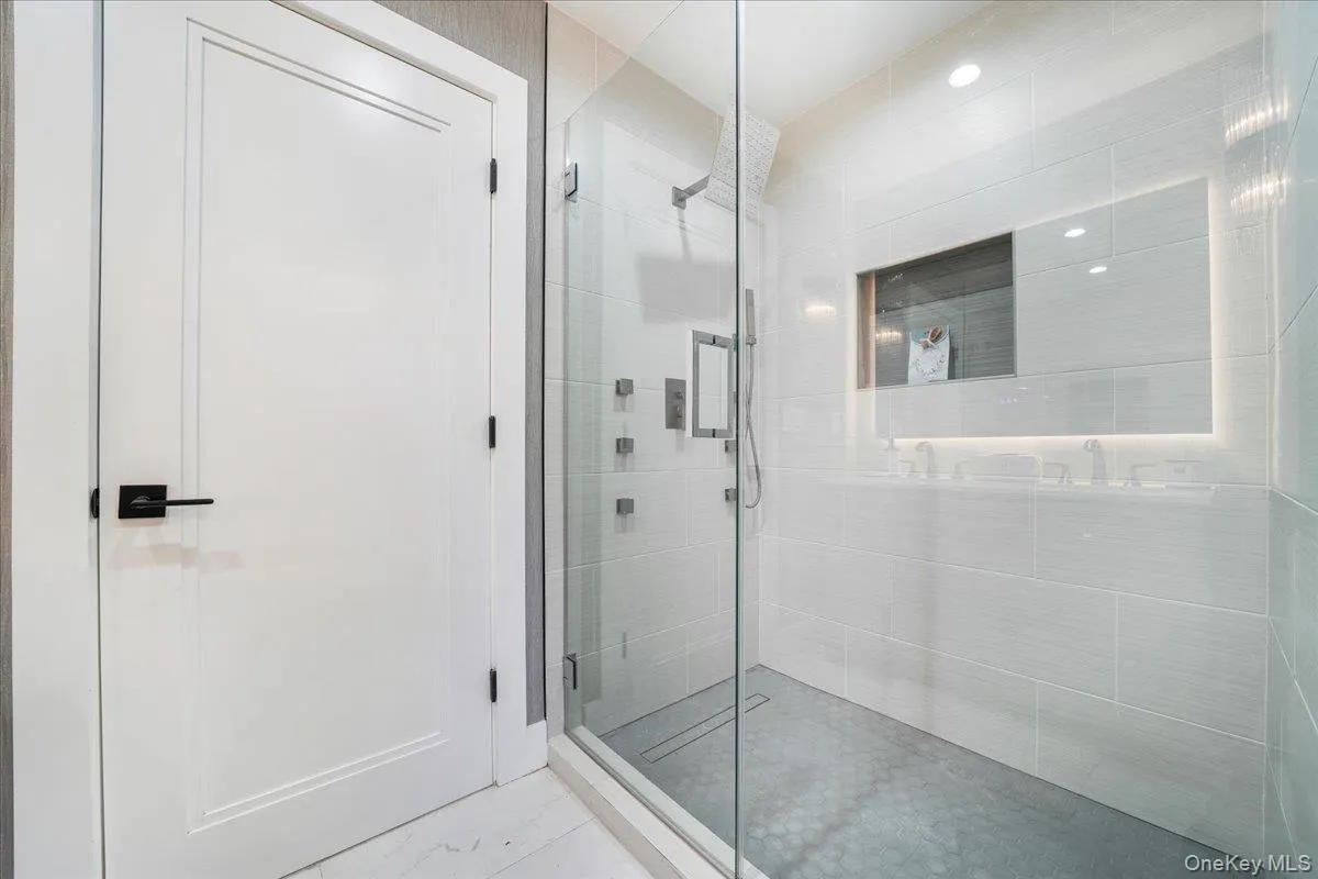 Bathroom featuring a shower stall Bathroom featuring a shower stall