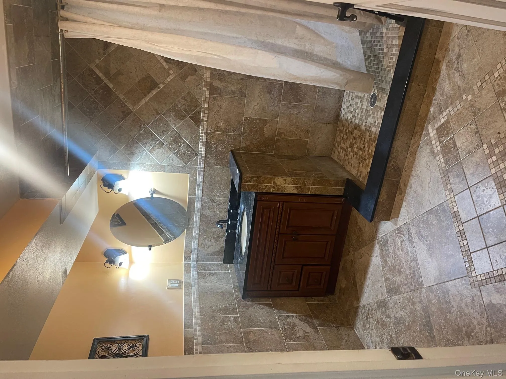 Bathroom with vanity, a tile shower, and tile walls Bathroom with vanity, a tile shower, and tile walls