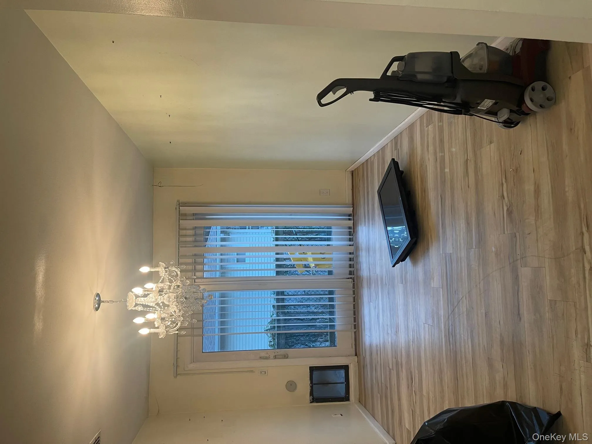 Dining room featuring light wood-style flooring and a chandelier Dining room featuring light wood-style flooring and a chandelier