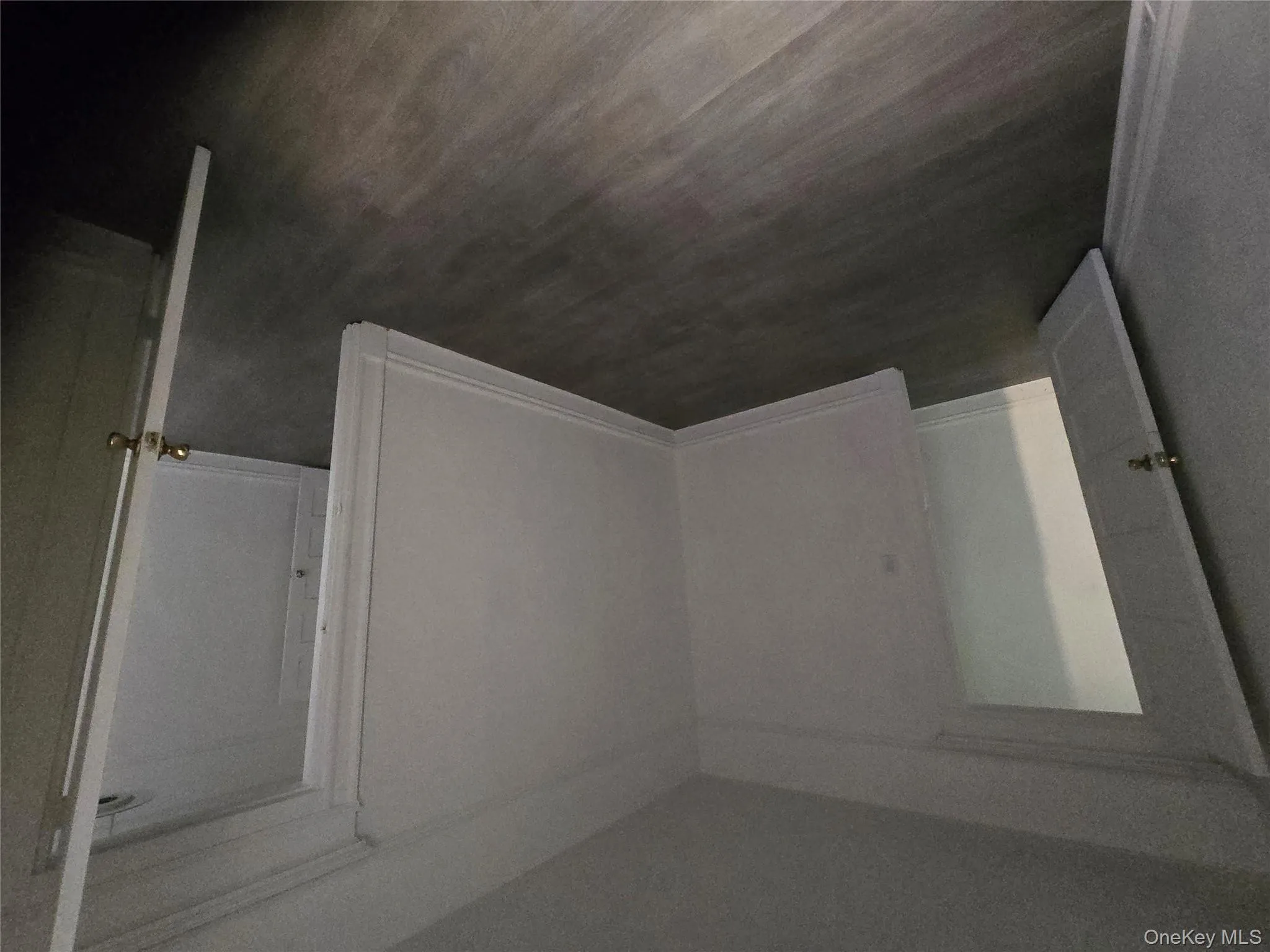 Unfurnished bedroom featuring dark wood-type flooring and baseboards Unfurnished bedroom featuring dark wood-type flooring and baseboards