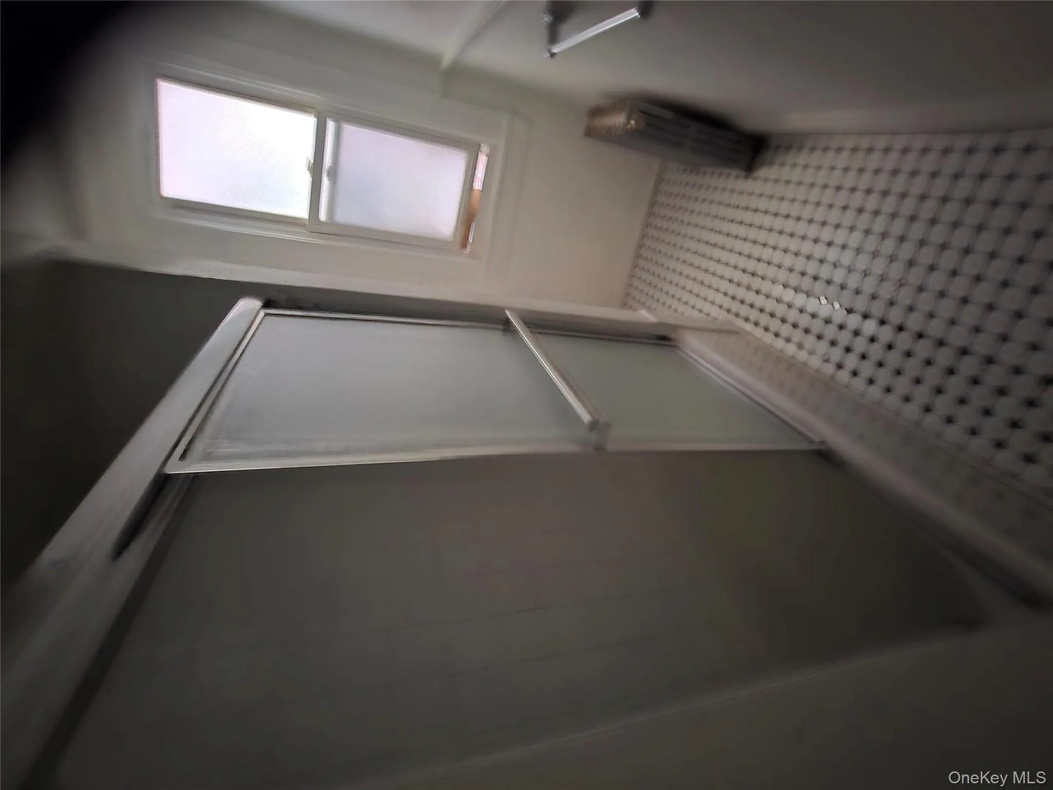 Bathroom with a stall shower, radiator heating unit, and light tile patterned flooring Bathroom with a stall shower, radiator heating unit, and light tile patterned flooring