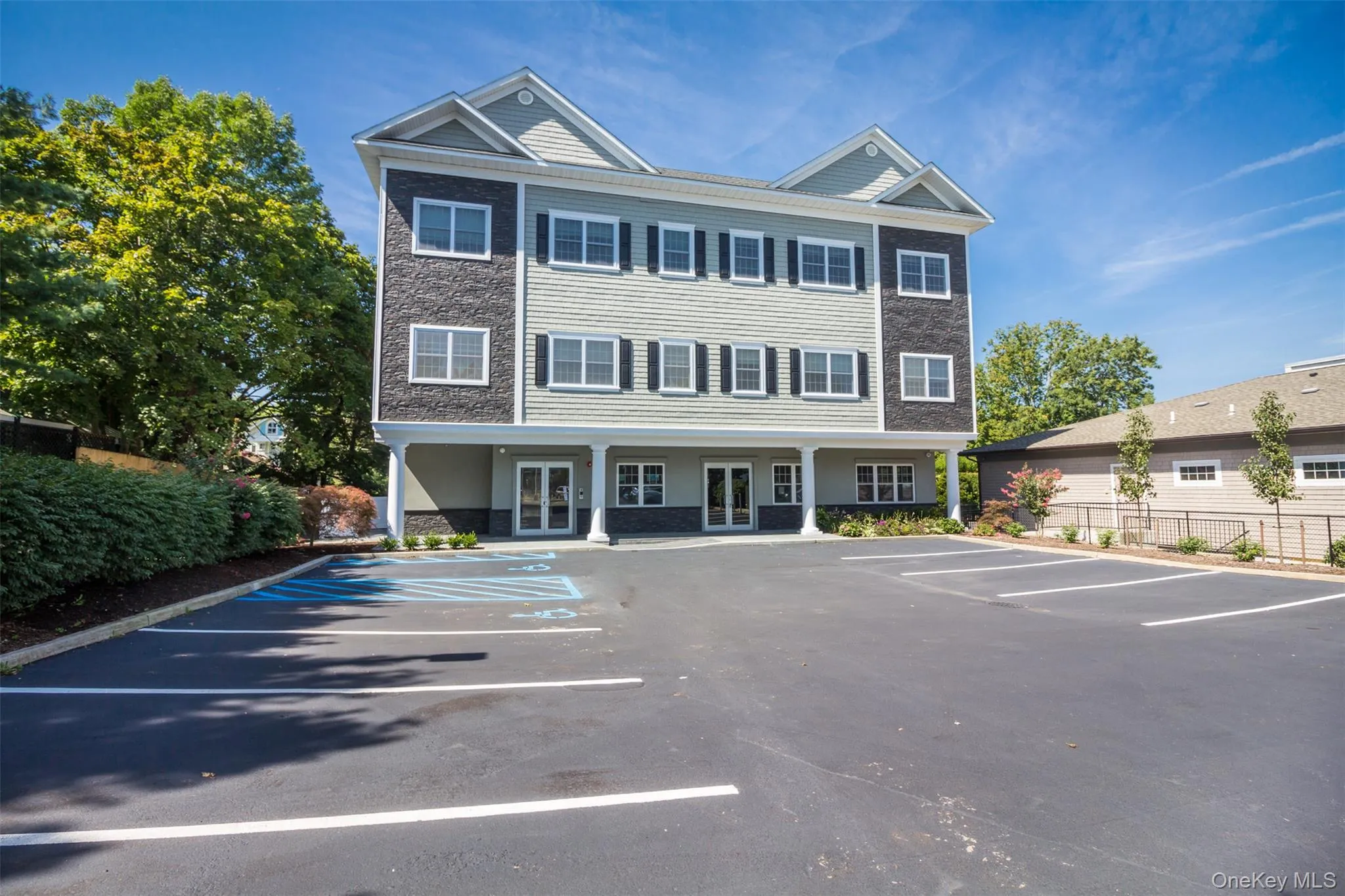 View of building exterior with uncovered parking View of building exterior with uncovered parking