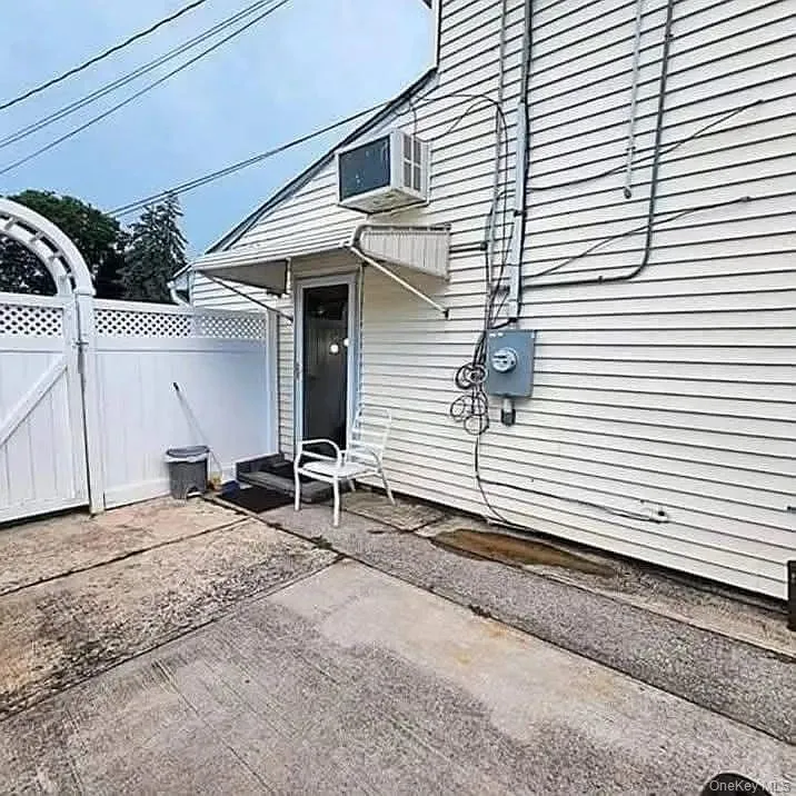 View of patio featuring a gate View of patio featuring a gate