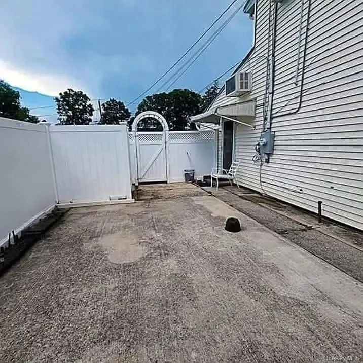 View of yard featuring a gate and a patio View of yard featuring a gate and a patio
