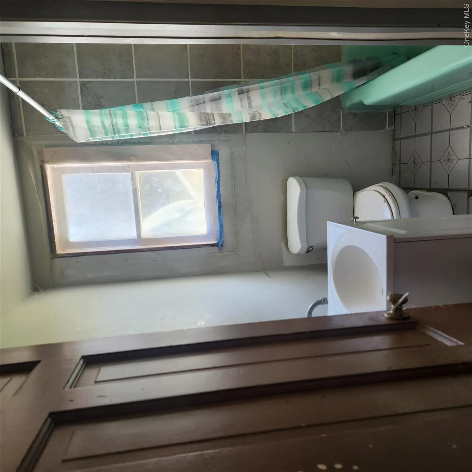 Full bathroom featuring vanity, light tile patterned floors, and shower / bathtub combination with curtain Full bathroom featuring vanity, light tile patterned floors, and shower / bathtub combination with curtain