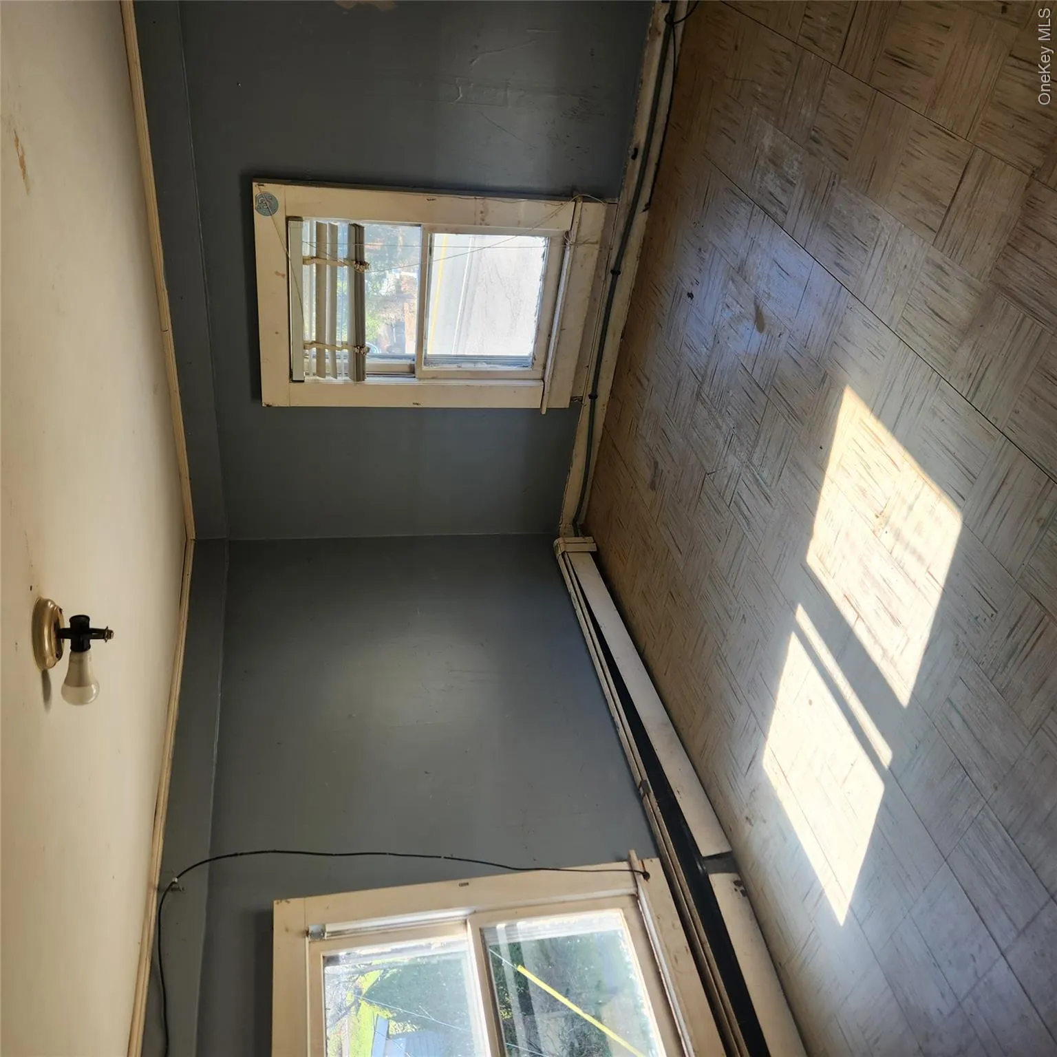 Unfurnished room with a baseboard heating unit Unfurnished room with a baseboard heating unit