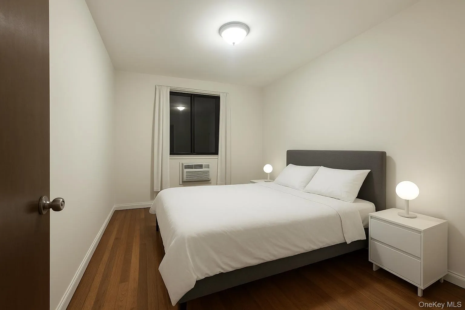 Bedroom with dark wood finished floors Bedroom with dark wood finished floors