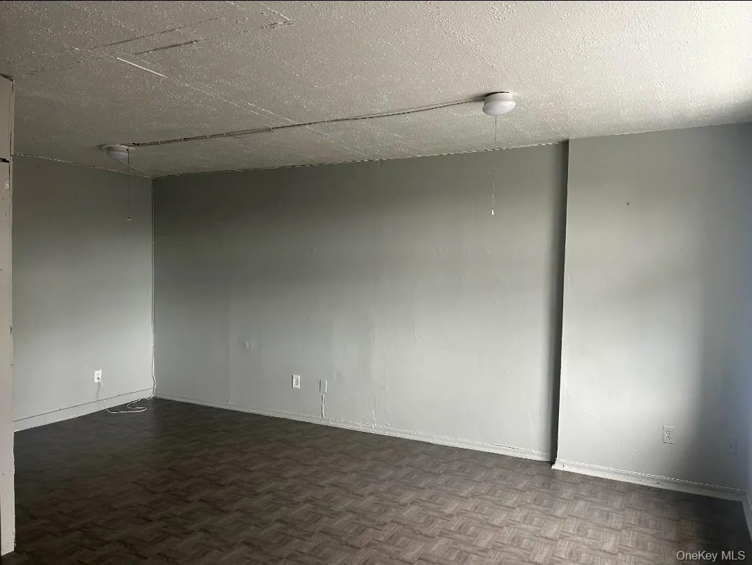 Empty room with a textured ceiling Empty room with a textured ceiling