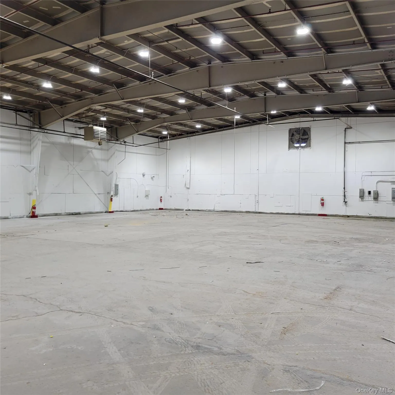 Miscellaneous room featuring a heating unit and a garage Miscellaneous room featuring a heating unit and a garage
