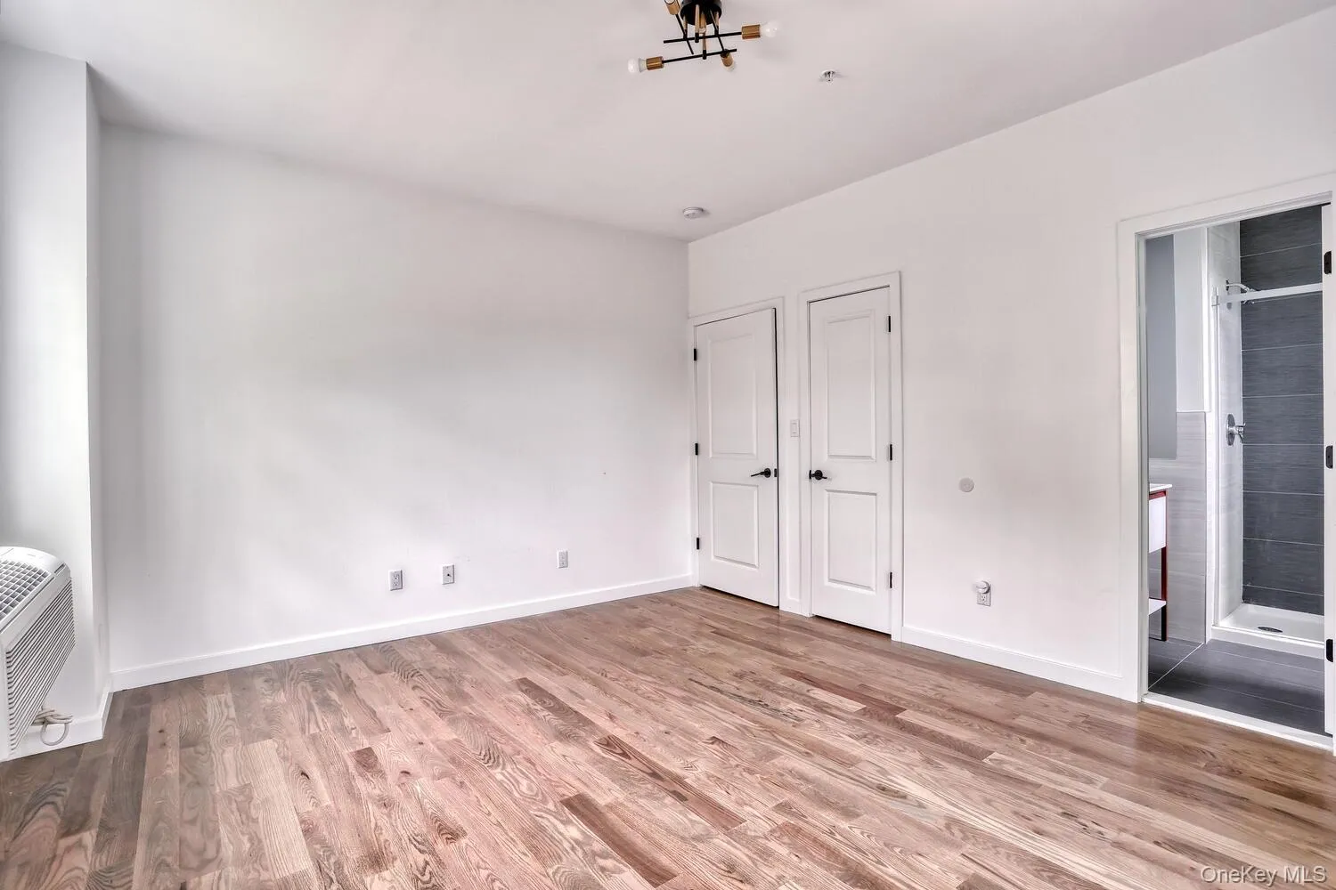 Primary Bedroom with a glimpse of the ensuite bath. Primary Bedroom with a glimpse of the ensuite bath.