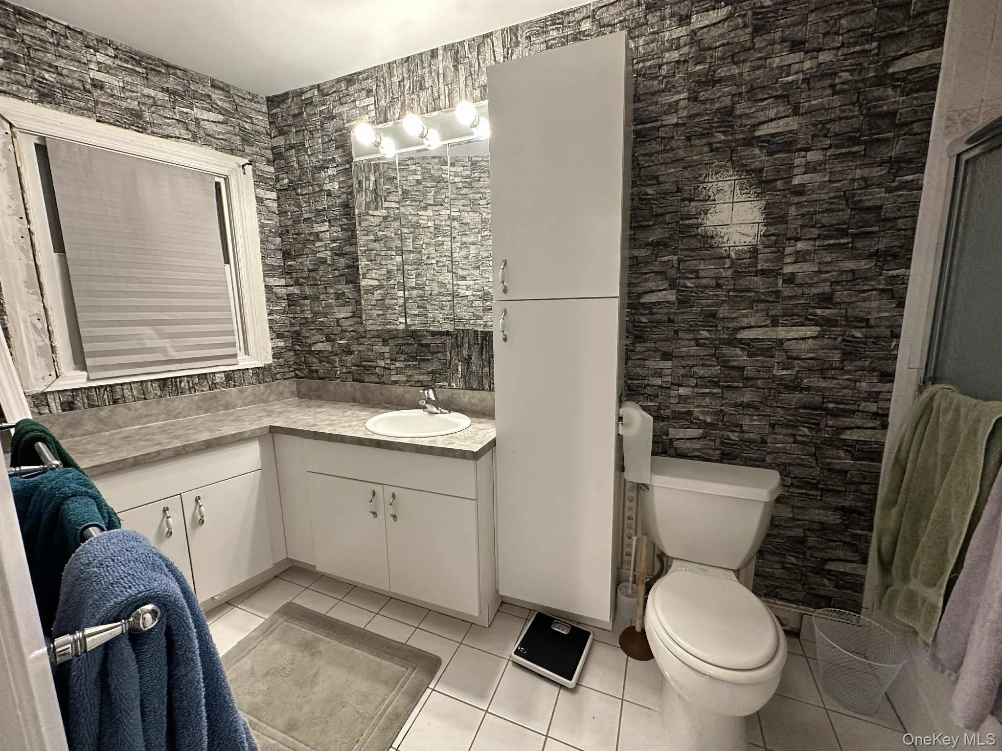 Full bathroom featuring light tile patterned flooring and vanity Full bathroom featuring light tile patterned flooring and vanity