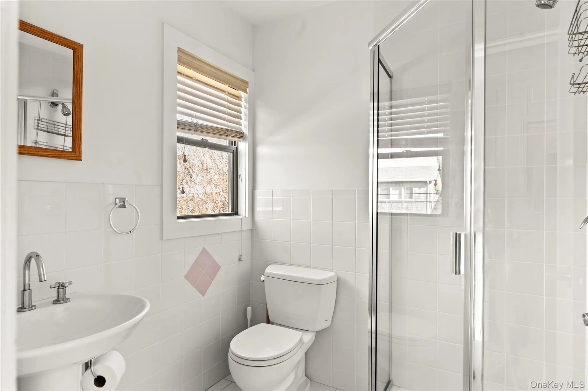 Full bathroom with a stall shower and tile walls Full bathroom with a stall shower and tile walls