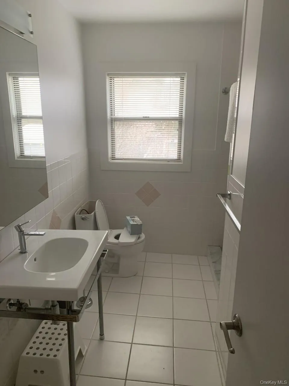 Bathroom with light tile patterned floors, tile walls, and a walk in shower Bathroom with light tile patterned floors, tile walls, and a walk in shower